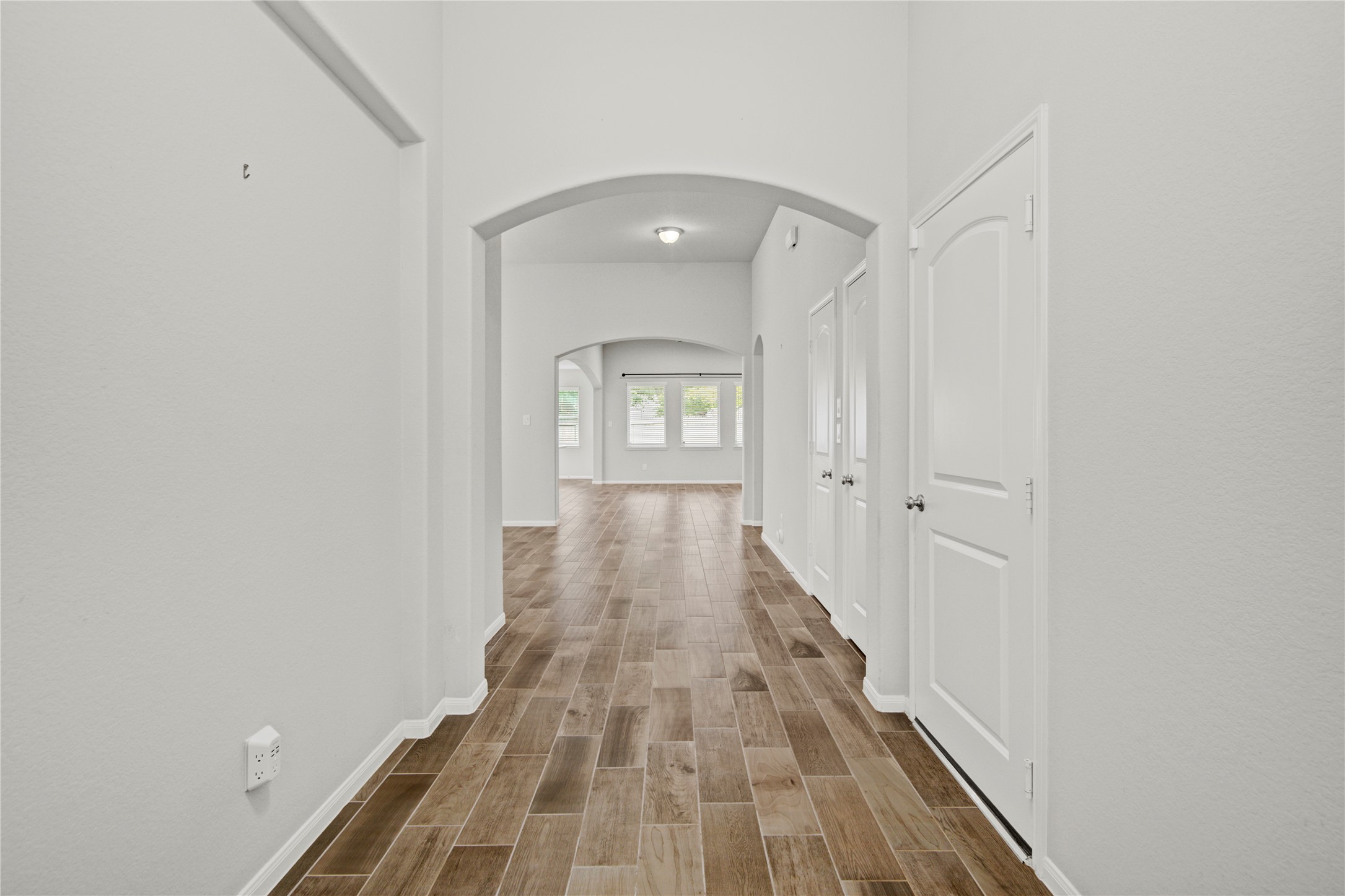 1314 Orchard Ridge Lane Tomball, TX 77375 - Photo 7 of 35 From the foyer, the home opens into a light-filled interior with arched openings and a natural flow into the main living spaces.