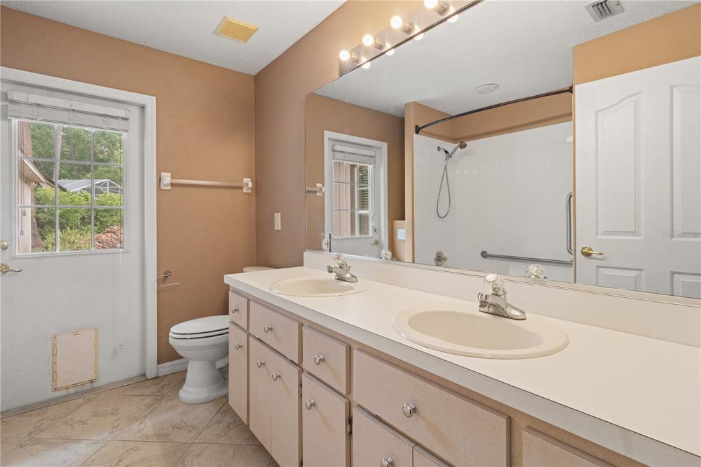 1617 Southeast 29th Terrace Ocala, FL 34471 - Photo 29 of 42 a bathroom with a sink toilet and a mirror