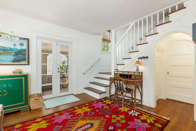 a kitchen with stainless steel appliances granite countertop a refrigerator a sink a stove with dining table and chairs