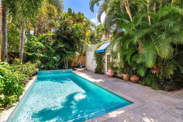 an aerial view of residential house with outdoor space and trees all around