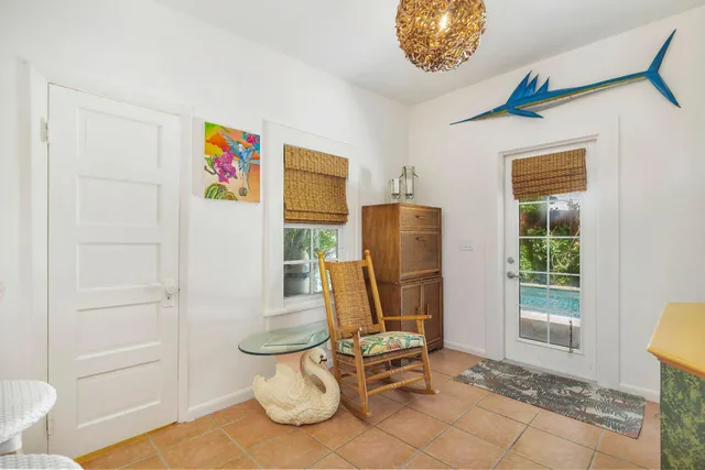 a view of a house with potted plants and large trees
