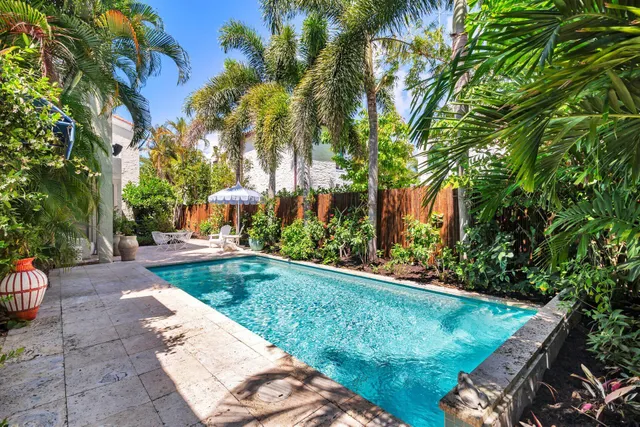 a view of a patio with table and chairs under an umbrella