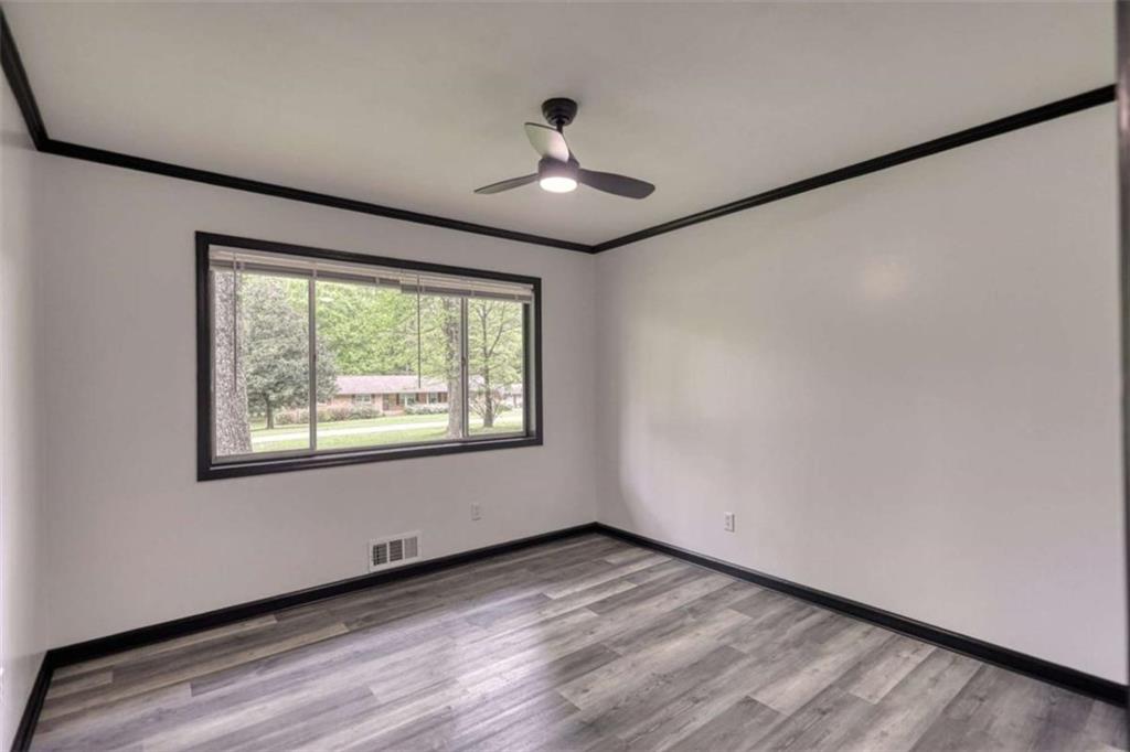 555 Joy Street Jackson, GA 30233 - Photo 29 of 56 a view of an empty room with wooden floor and a window