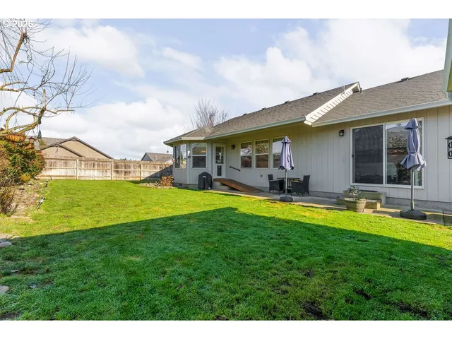 a view of house with swimming pool yard and outdoor seating