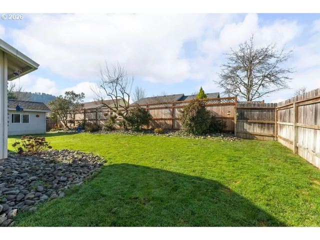 a view of yard with swimming pool and green space
