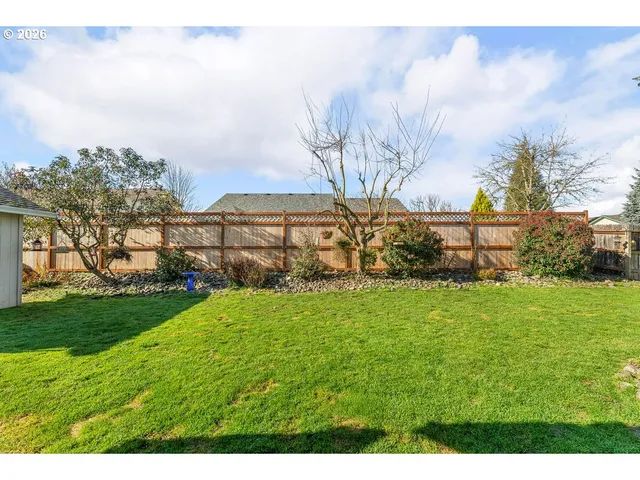 a view of a garden with a building in the background