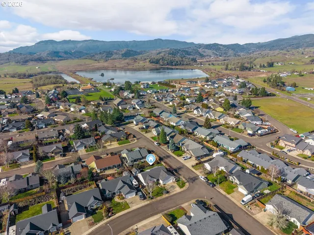 an aerial view of residential building with outdoor space and ocean view