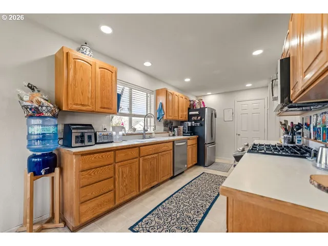 a kitchen with a sink a stove and cabinets