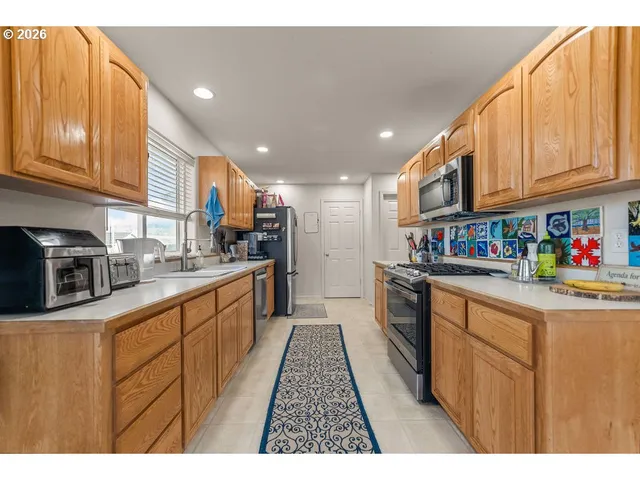 a kitchen with stainless steel appliances granite countertop a sink and cabinets