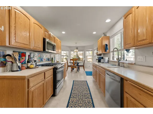 a kitchen with stainless steel appliances granite countertop a sink and cabinets