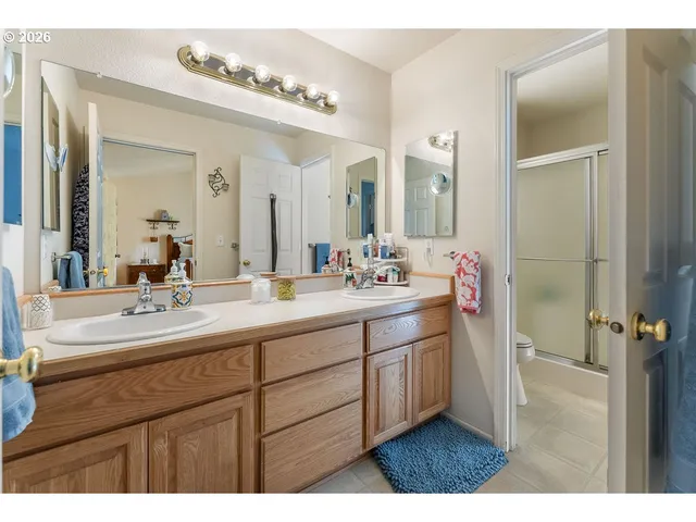 a bathroom with a double vanity sink mirror and double