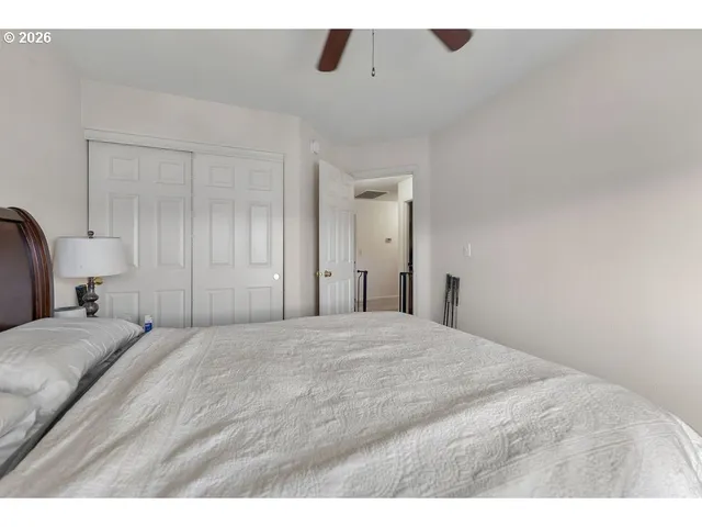 a large bedroom with a bed and a dresser