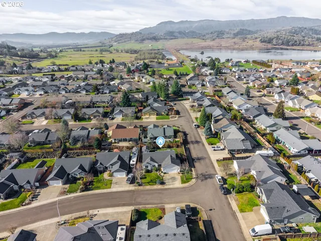 an aerial view of residential house with outdoor space and river