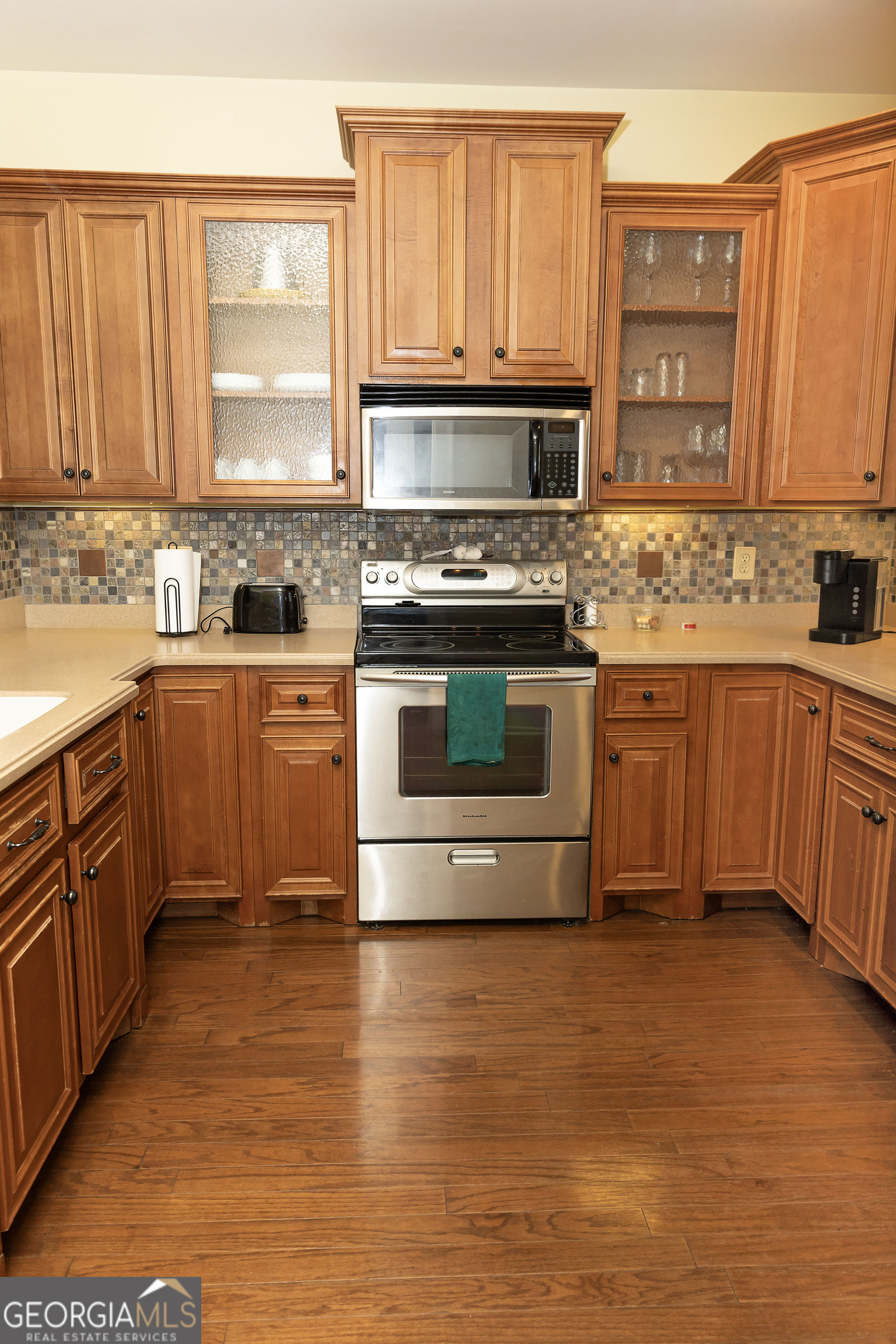 102 Arbors Court Dublin, GA 31021 - Photo 14 of 33 a kitchen with stainless steel appliances a stove sink and cabinets
