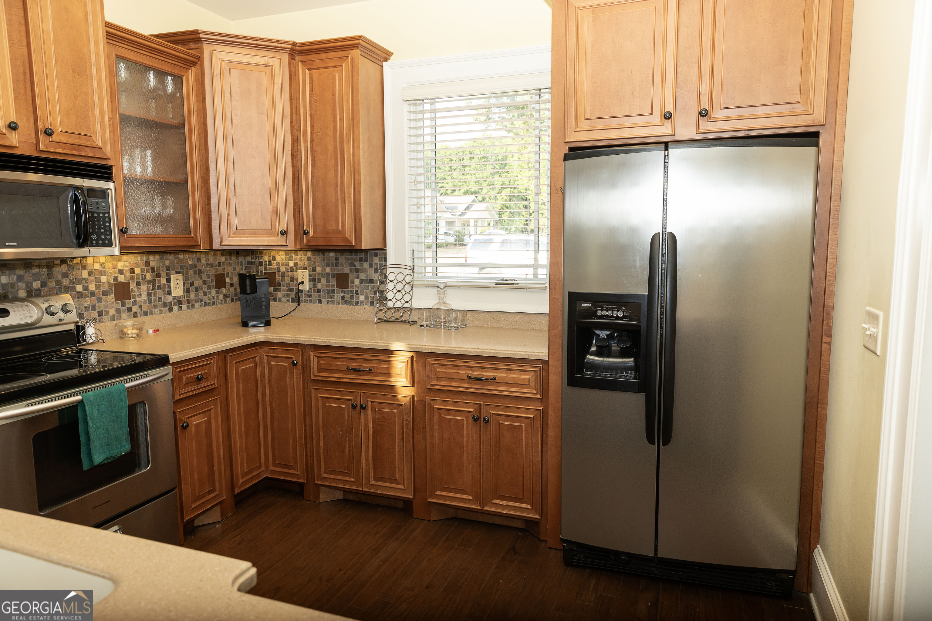 102 Arbors Court Dublin, GA 31021 - Photo 16 of 33 a kitchen with stainless steel appliances granite countertop a refrigerator a sink and white cabinets