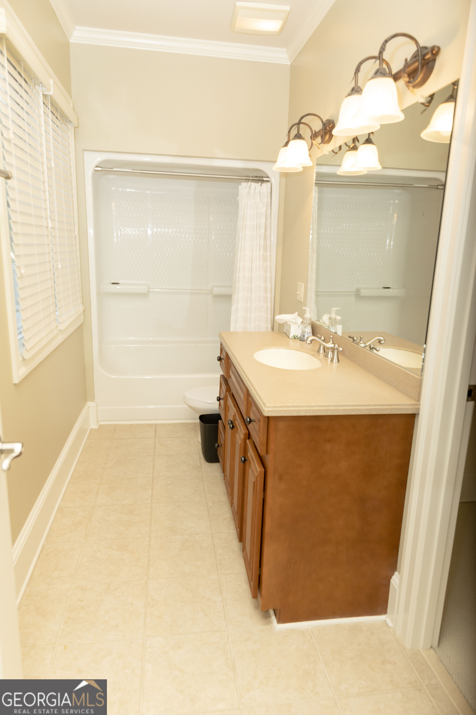 102 Arbors Court Dublin, GA 31021 - Photo 23 of 33 a bathroom with a double vanity sink a mirror and a bathtub