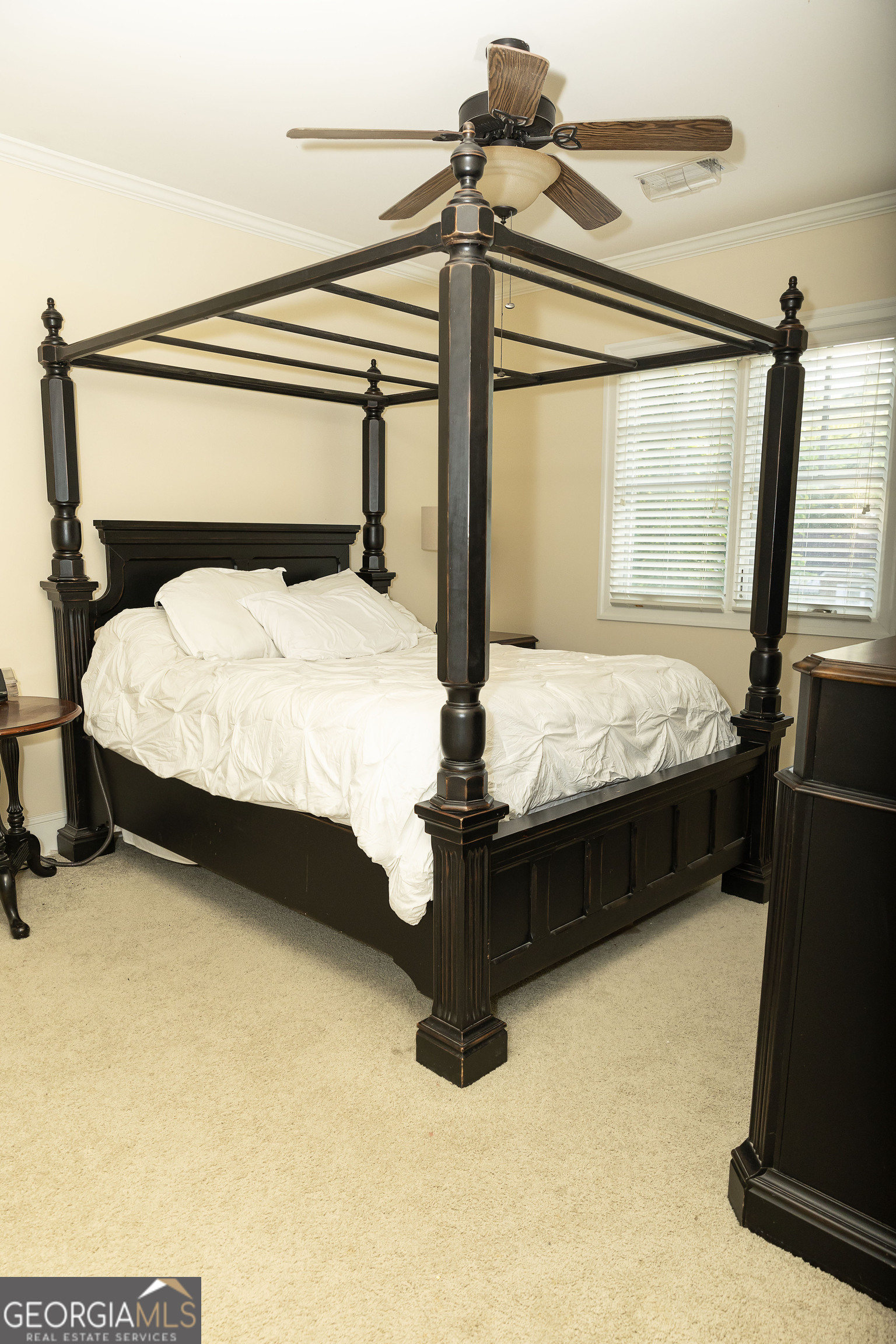 102 Arbors Court Dublin, GA 31021 - Photo 25 of 33 a bed sitting in a bedroom next to a window