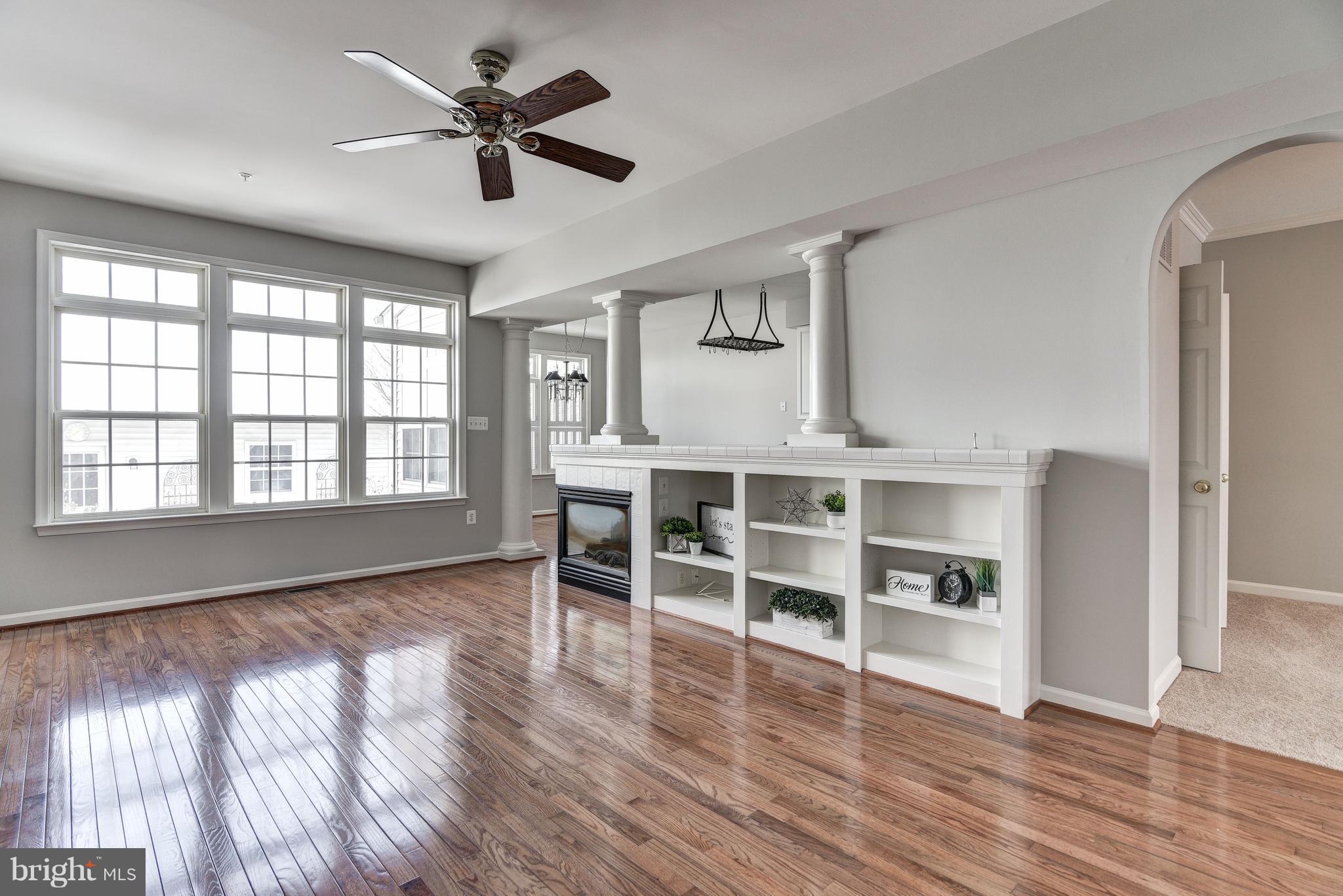 3005 Annas Terrace Frederick, MD 21701 - Photo 3 of 29 wooden floor in an empty room with a window and a kitchen