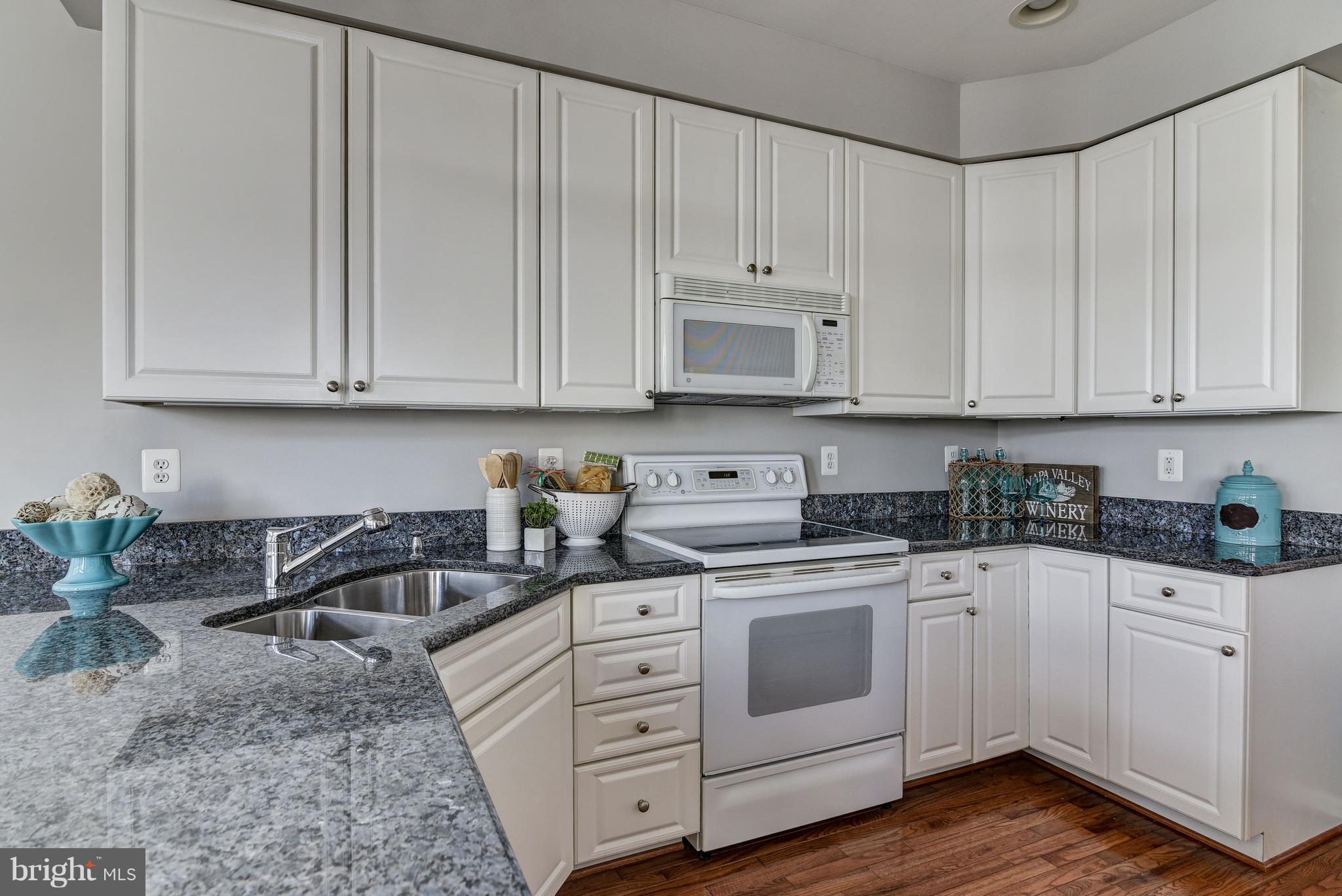 3005 Annas Terrace Frederick, MD 21701 - Photo 8 of 29 a kitchen with granite countertop white cabinets and white appliances