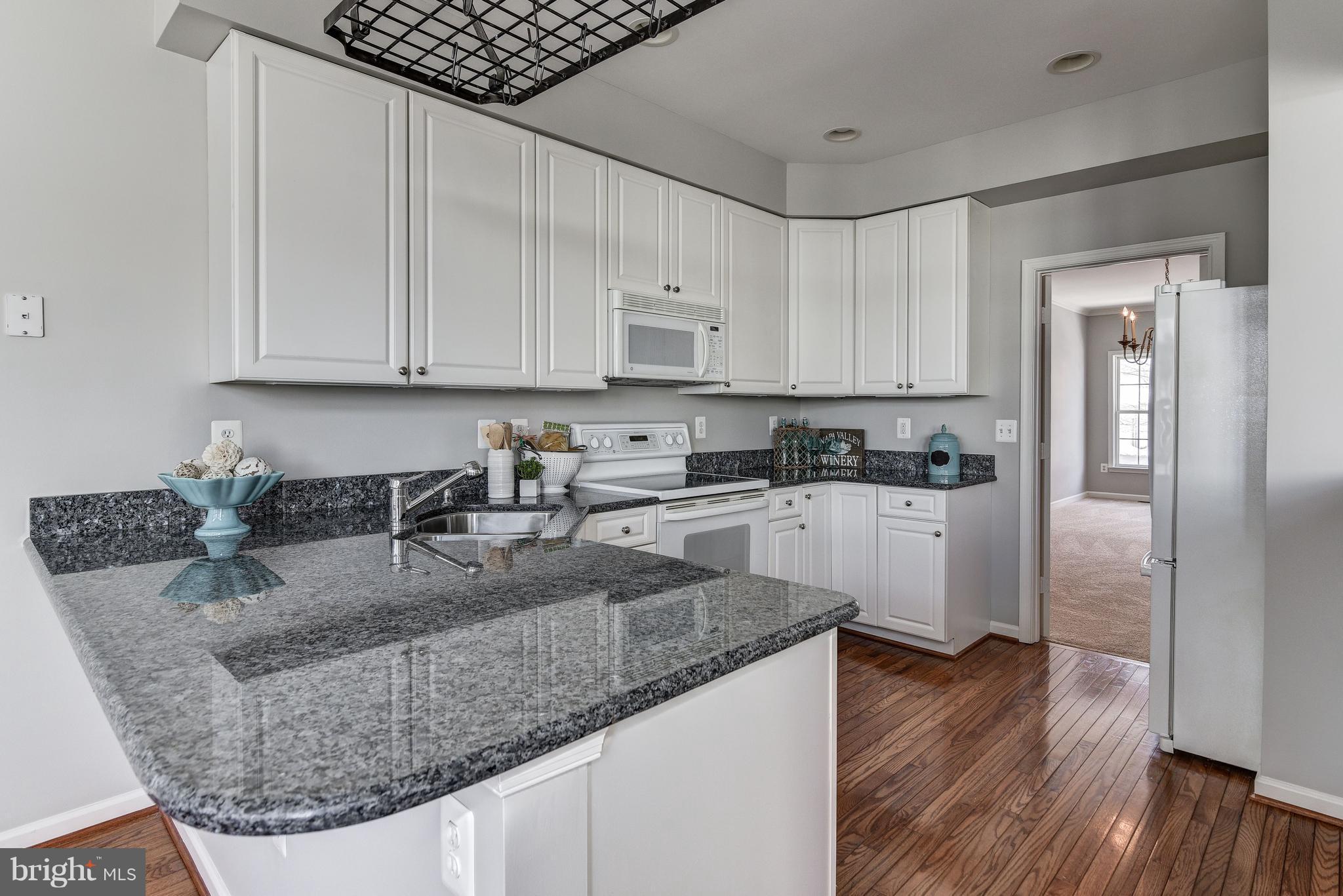 3005 Annas Terrace Frederick, MD 21701 - Photo 10 of 29 a kitchen with stainless steel appliances granite countertop a sink stove and refrigerator