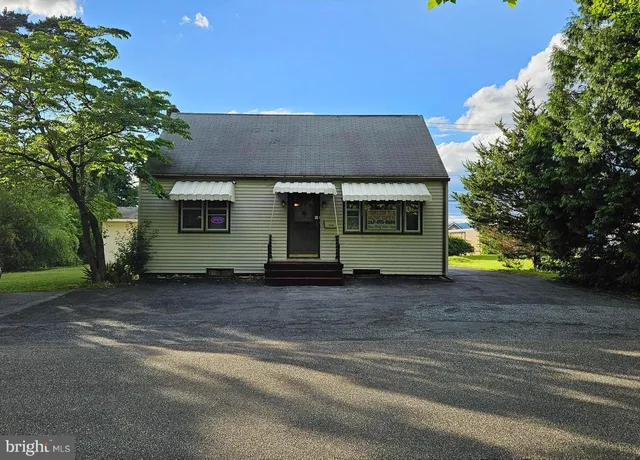 a view of a house with a yard and garage