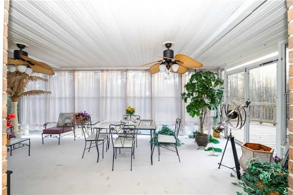 a dining room with furniture and a potted plant