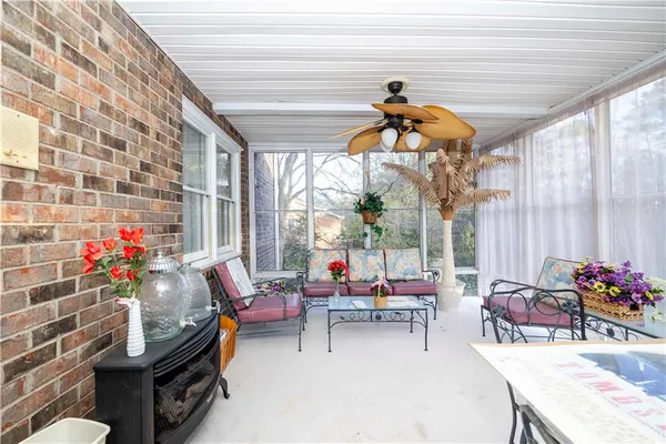 a living room with furniture and a potted plant