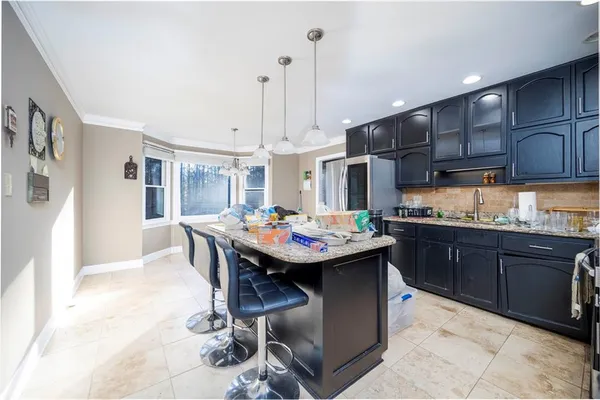 a kitchen with granite countertop a sink and cabinets