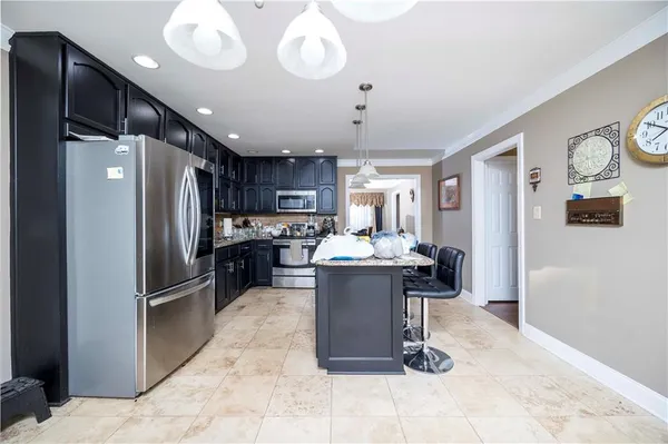 a kitchen with a refrigerator a sink and cabinets