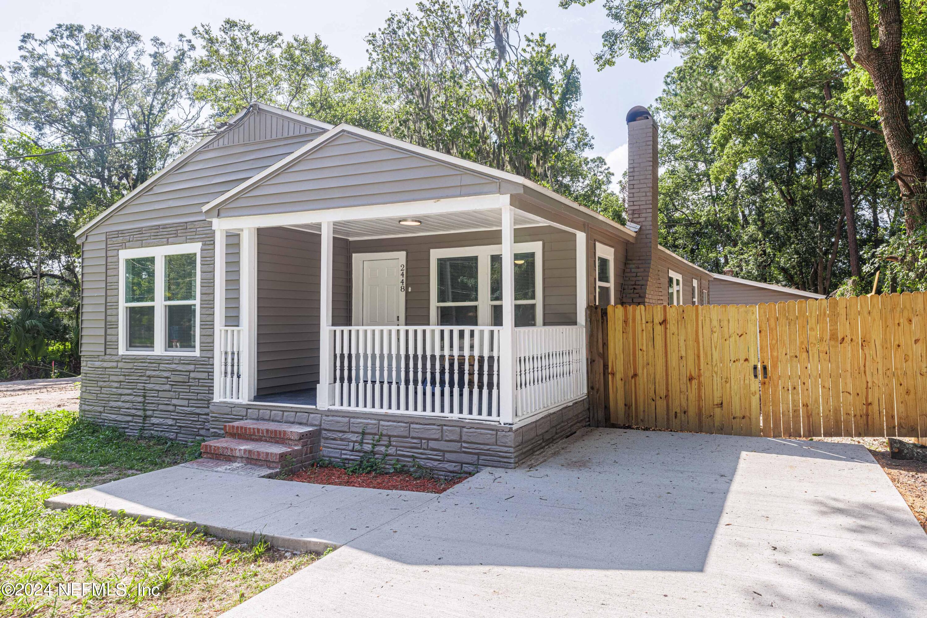 2448 Parental Home Road Jacksonville, FL 32216 - Photo 1 of 21 a front view of a house with a garden
