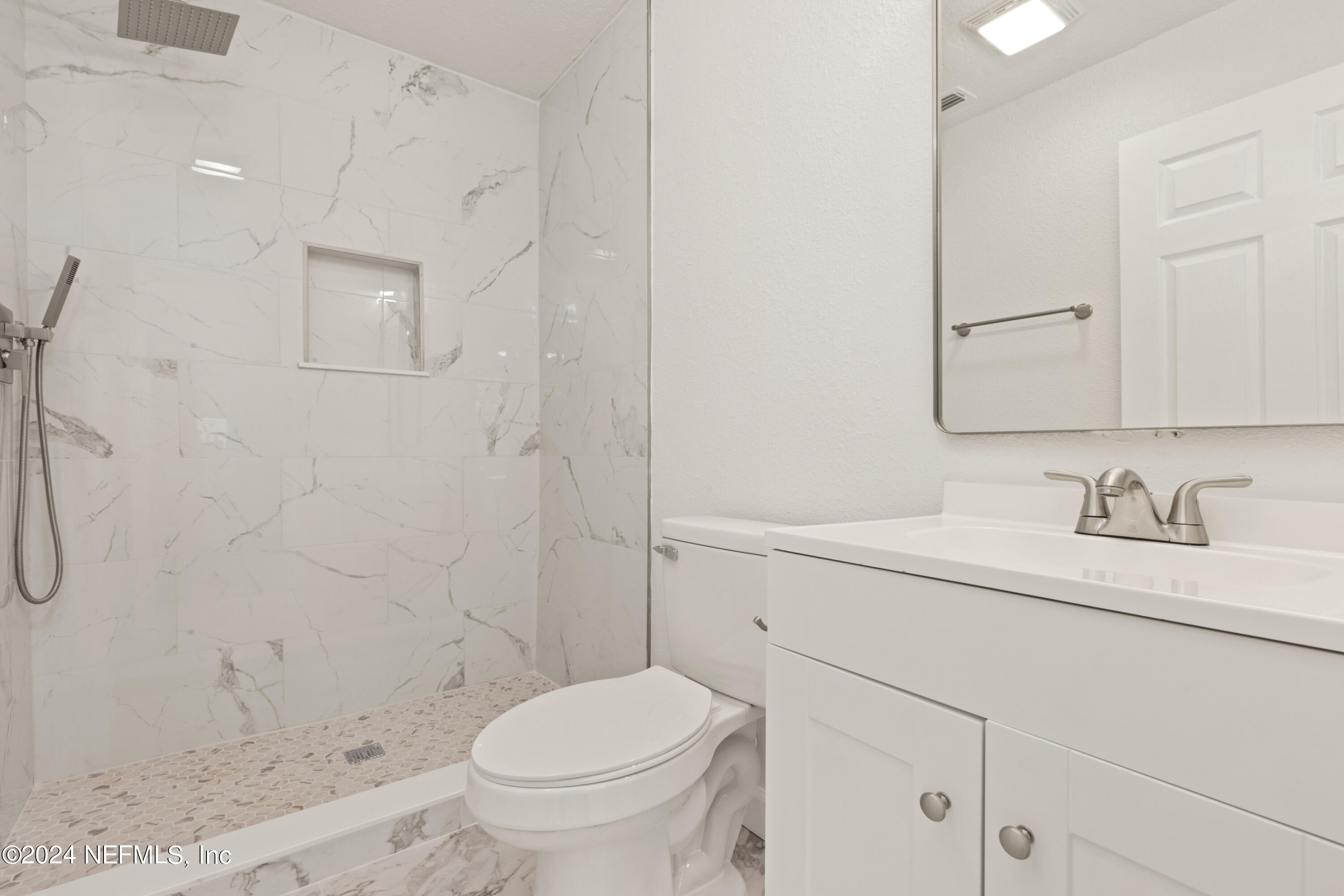 2448 Parental Home Road Jacksonville, FL 32216 - Photo 12 of 21 a bathroom with a granite countertop sink a toilet and a shower