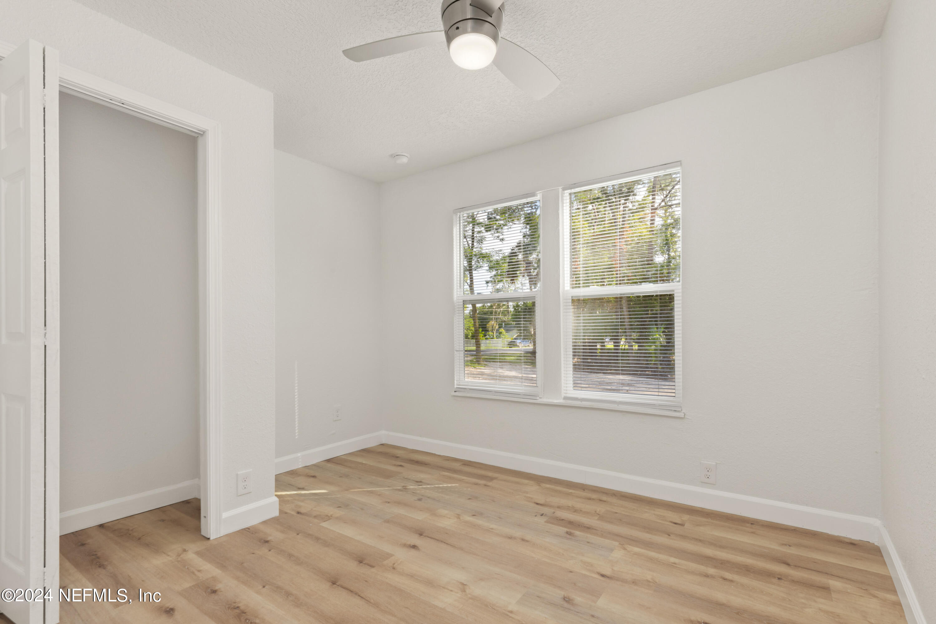 2448 Parental Home Road Jacksonville, FL 32216 - Photo 13 of 21 an empty room with wooden floor and windows