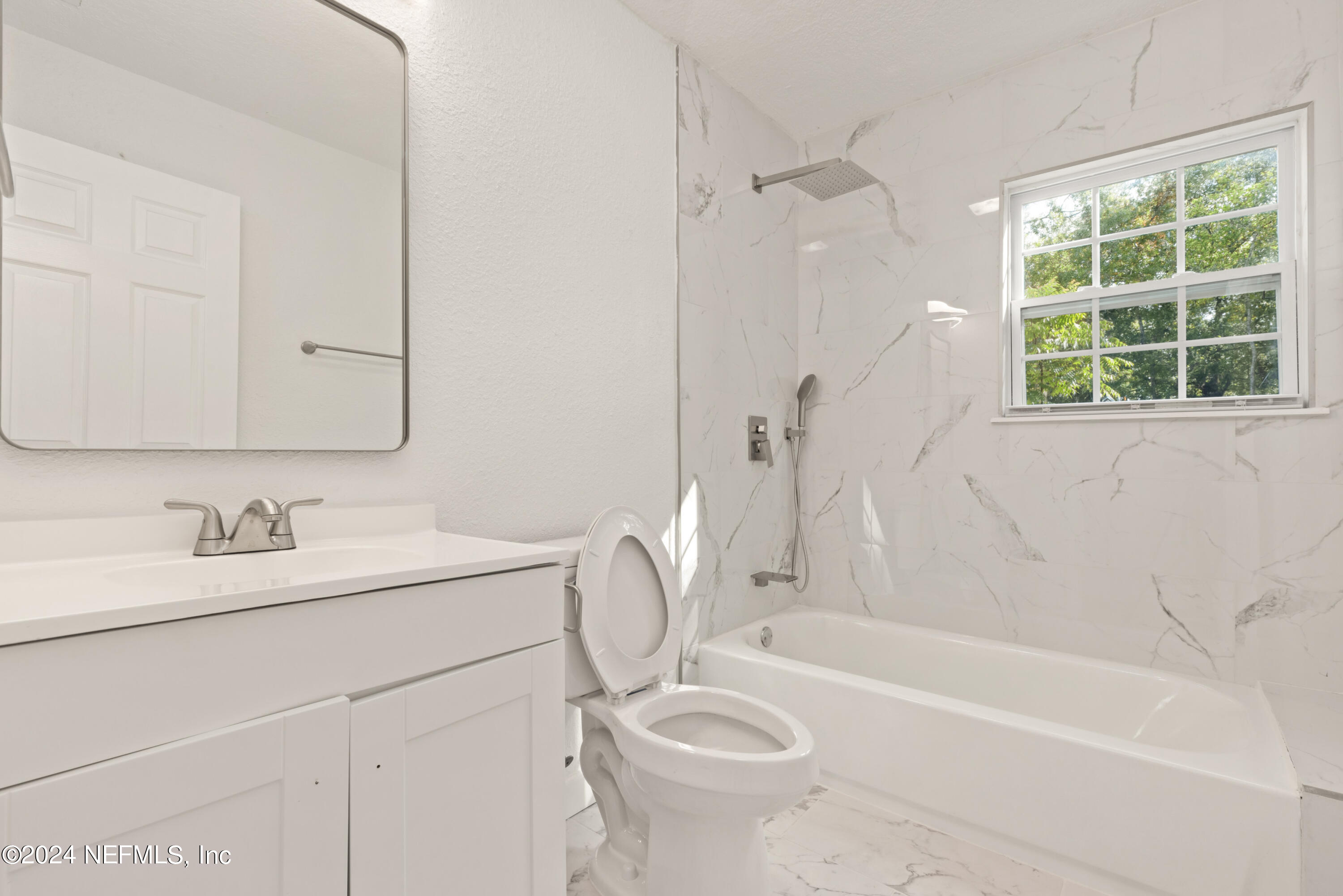 2448 Parental Home Road Jacksonville, FL 32216 - Photo 15 of 21 a bathroom with a sink a toilet and a bathtub