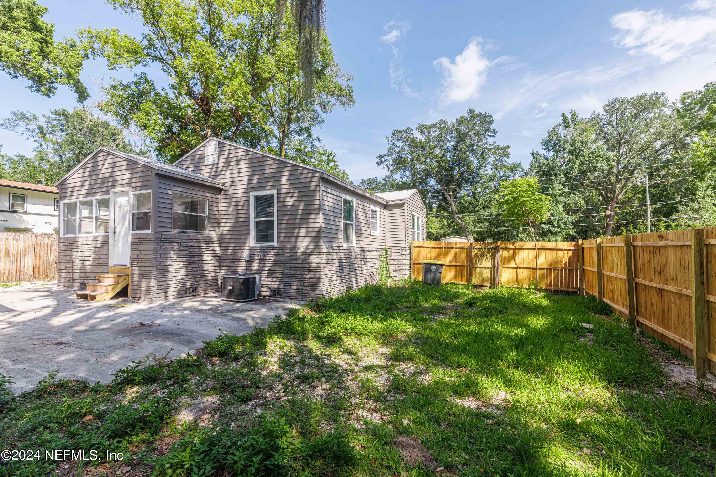 2448 Parental Home Road Jacksonville, FL 32216 - Photo 17 of 21 a view of a house with backyard and a tree