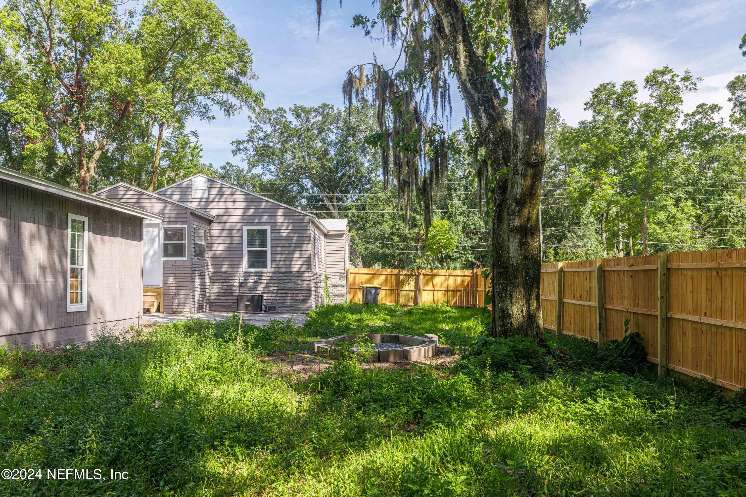 2448 Parental Home Road Jacksonville, FL 32216 - Photo 18 of 21 a view of a garden with a large tree
