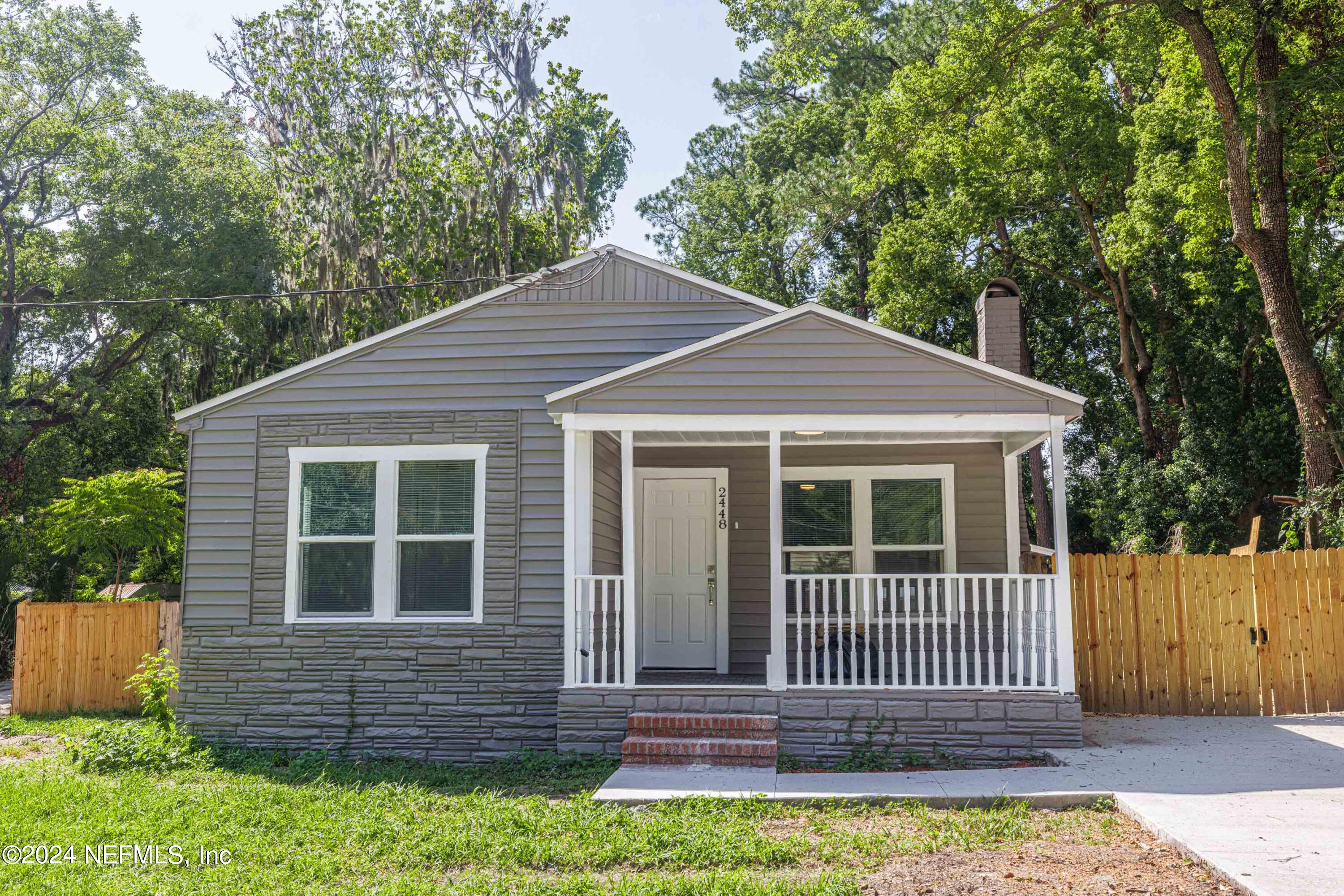2448 Parental Home Road Jacksonville, FL 32216 - Photo 2 of 21 a front view of a house with a garden