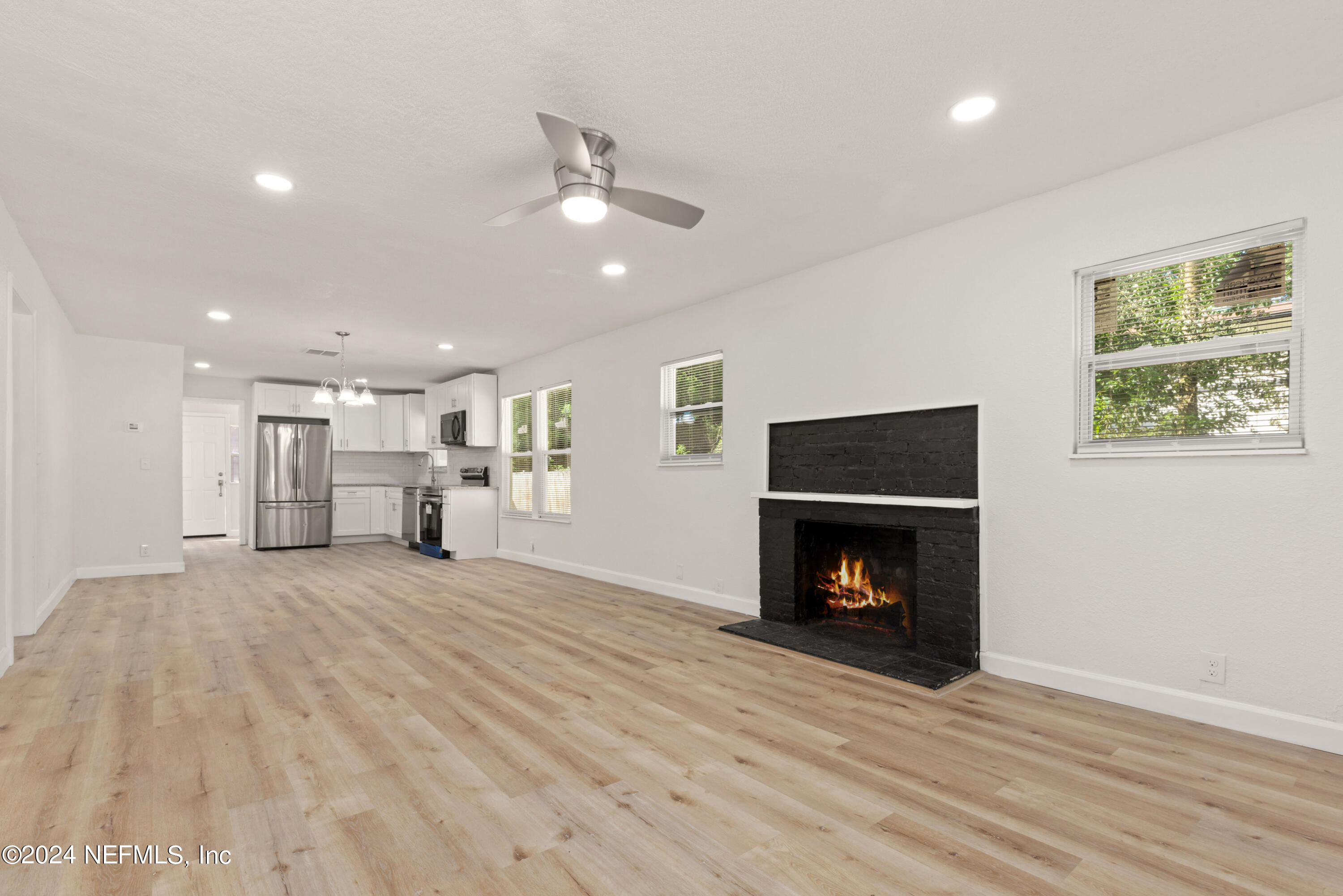 2448 Parental Home Road Jacksonville, FL 32216 - Photo 3 of 21 a view of a livingroom with a fireplace wooden floor and window