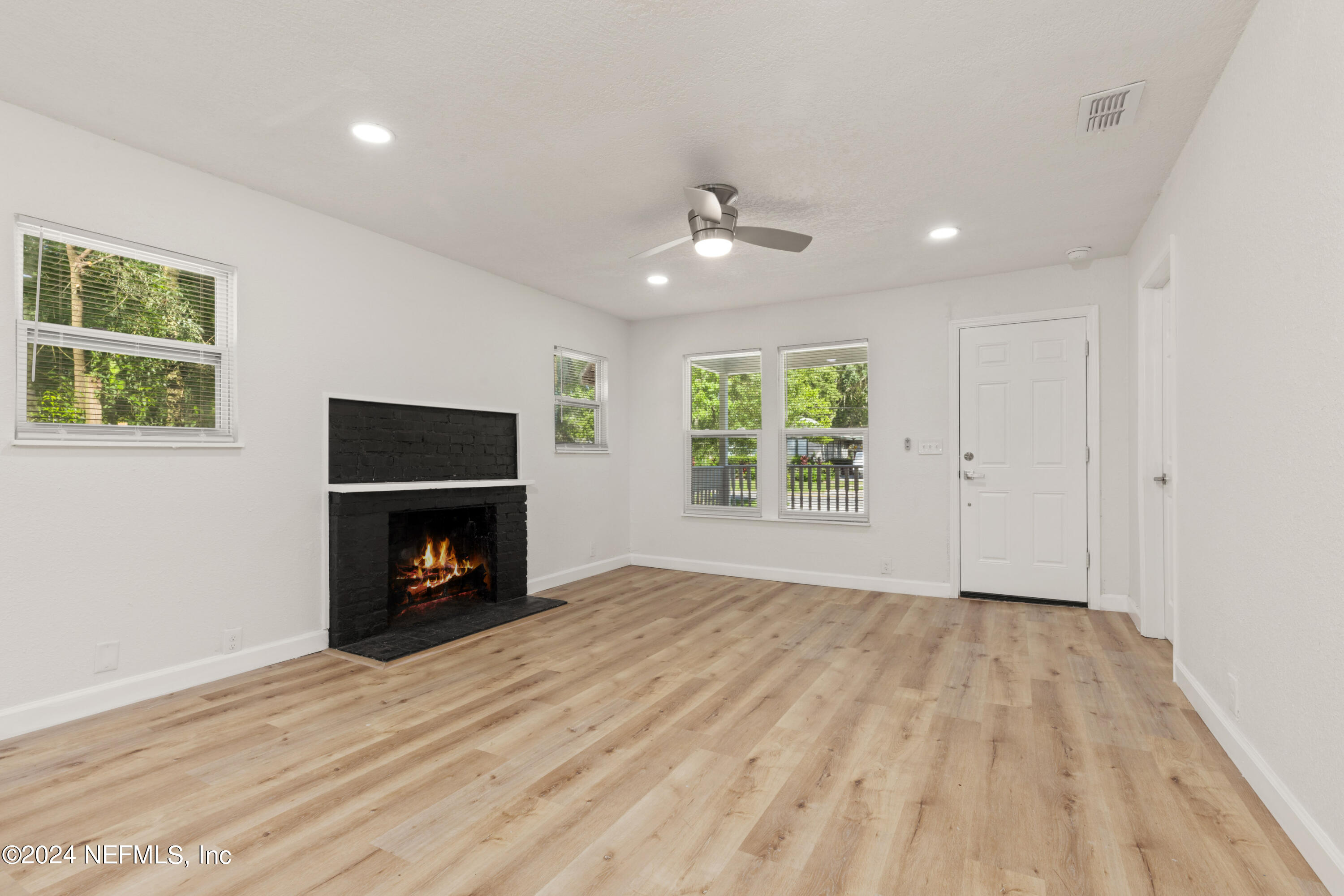 2448 Parental Home Road Jacksonville, FL 32216 - Photo 4 of 21 wooden floor in an empty room with a window