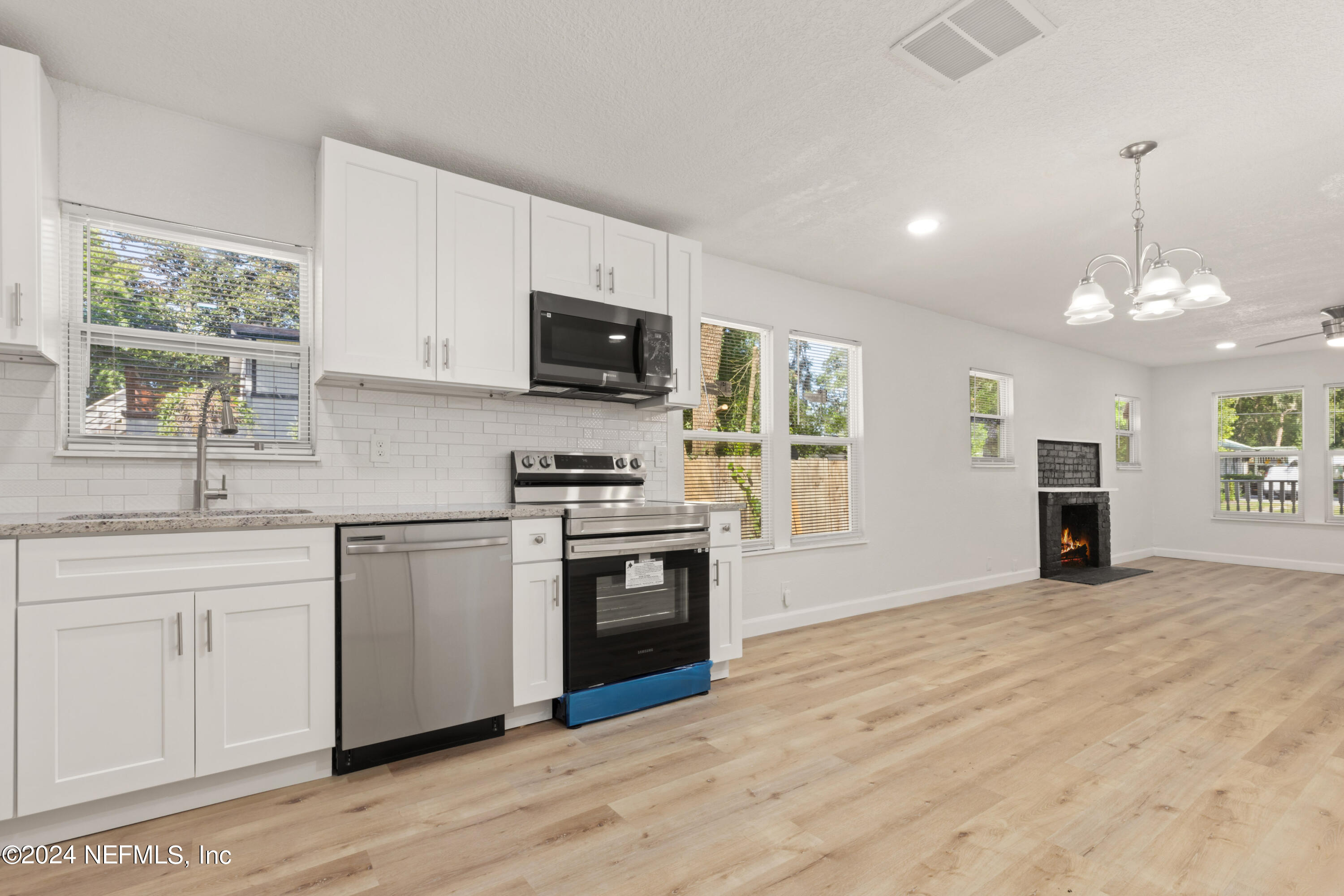 2448 Parental Home Road Jacksonville, FL 32216 - Photo 8 of 21 a kitchen with a stove a sink and a microwave