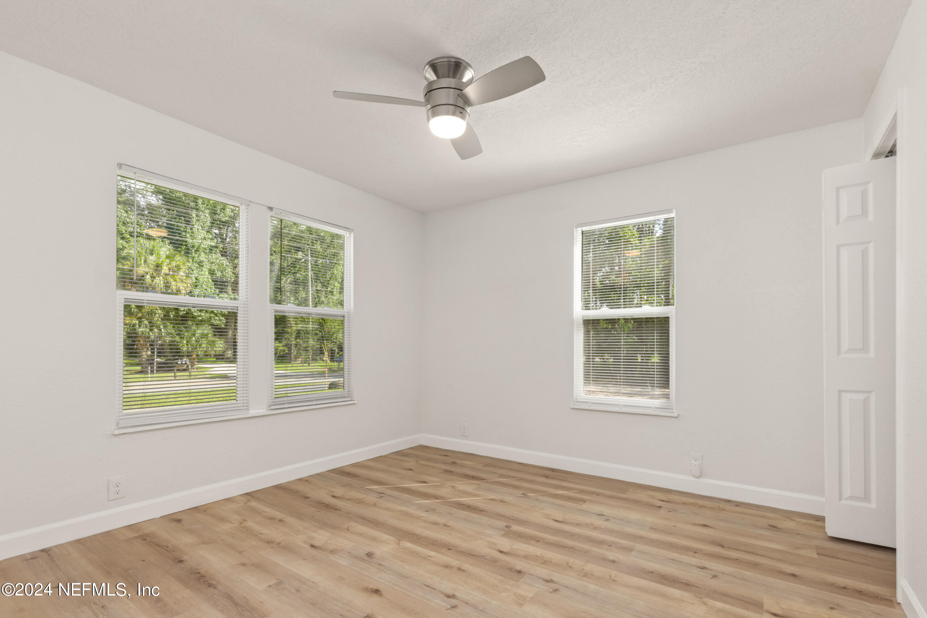 2448 Parental Home Road Jacksonville, FL 32216 - Photo 10 of 21 a view of an empty room with wooden floor and a window