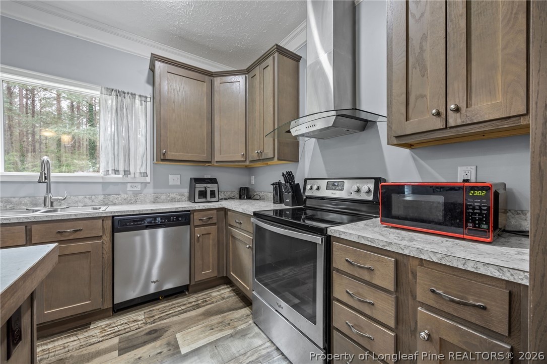 2252 Old Stage Road South Erwin, NC 28339 - Photo 6 of 47 a kitchen with stainless steel appliances granite countertop a stove a sink and a microwave
