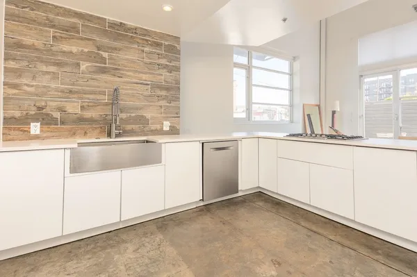 a view of kitchen with refrigerator and microwave