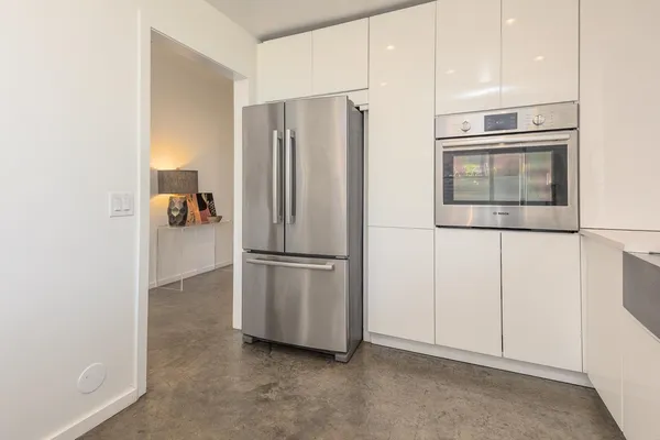 a kitchen with stainless steel appliances a refrigerator and a sink