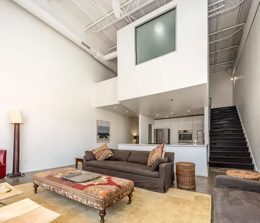 a view of living room with furniture and wooden floor