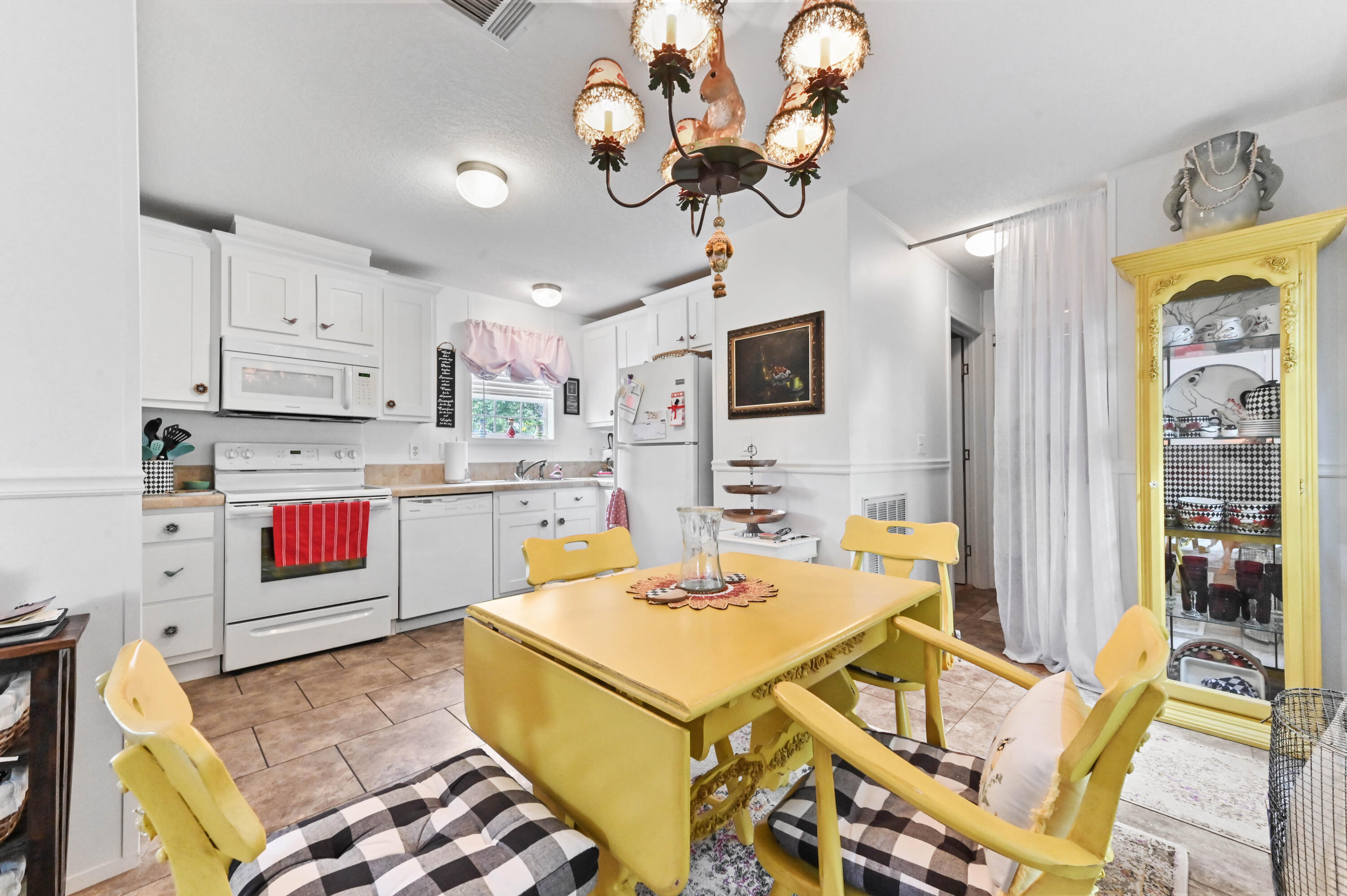 2 East View Street Lantana, FL 33462 - Photo 9 of 28 a kitchen with stainless steel appliances granite countertop a stove a sink dishwasher a dining table and chairs with wooden floor
