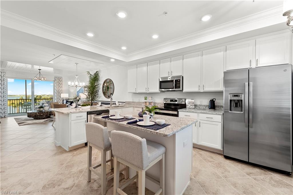 5651 Double Eagle Circle, Unit 4314 Immokalee, FL 34142 - Photo 2 of 20 a kitchen with a sink a counter top space stainless steel appliances and cabinets