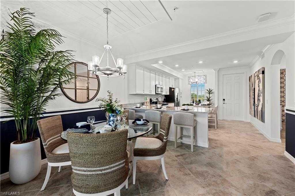 5651 Double Eagle Circle, Unit 4314 Immokalee, FL 34142 - Photo 9 of 20 a living room with furniture a chandelier and a dining table