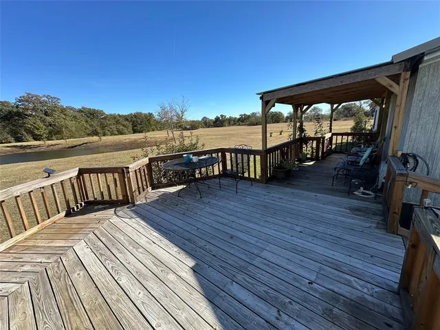 a view of a balcony with mountain view and wooden floor