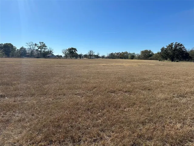 a front view of a house with barbeque oven and seating space