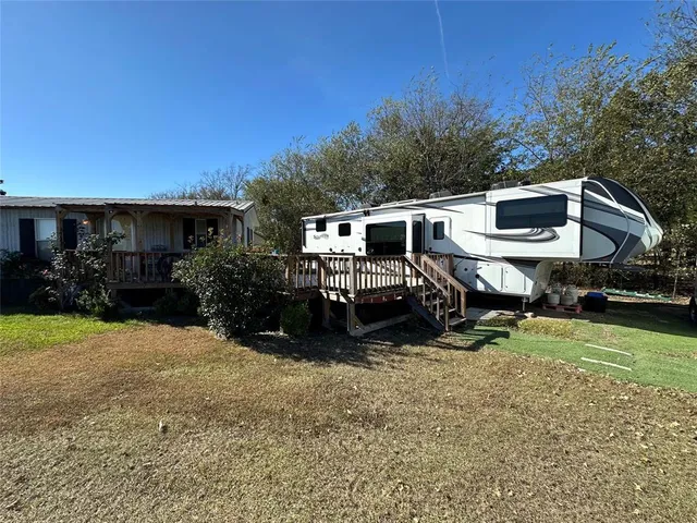 a view of a house with backyard porch and sitting area